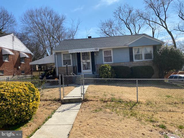 a front view of a house with a tree