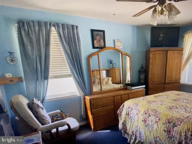 5905 Jamestown Road Hyattsville, MD 20782 - Photo 11 of 25 a bedroom with a bed and a chandelier