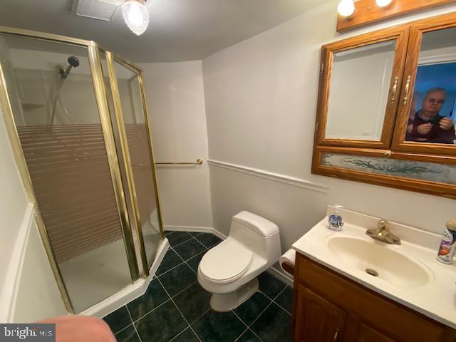 5905 Jamestown Road Hyattsville, MD 20782 - Photo 16 of 25 a bathroom with a sink a toilet a mirror and shower