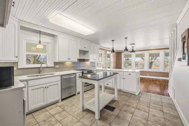 a kitchen with appliances cabinets and furniture