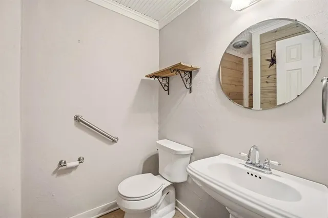 a white toilet sitting next to a bathroom sink