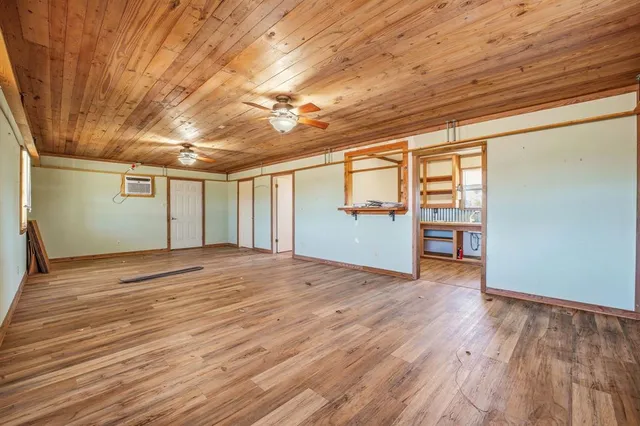 en empty room with wooden floor and natural light