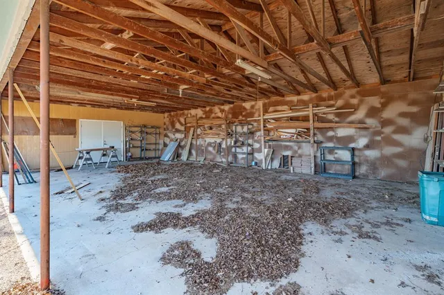 a view of a empty room with a wooden fence