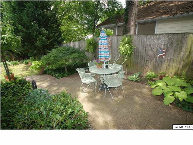 385 Minor Ridge Road Charlottesville, VA 22901 - Photo 13 of 15 a view of a backyard with table and chairs and a couple of flower plants