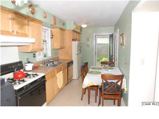 385 Minor Ridge Road Charlottesville, VA 22901 - Photo 3 of 15 a kitchen with stainless steel appliances granite countertop a stove a sink dishwasher and a refrigerator with wooden floor