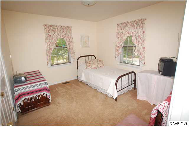385 Minor Ridge Road Charlottesville, VA 22901 - Photo 10 of 15 a living room with a bed furniture and a window