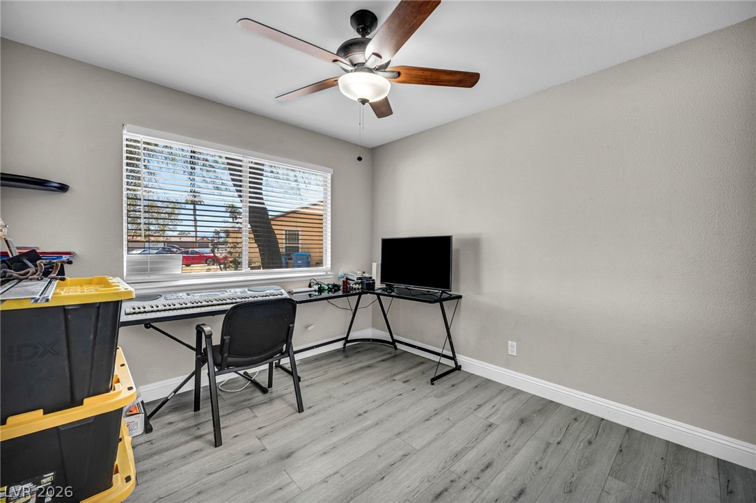 5882 Rio Tinto Way Las Vegas, NV 89110 - Photo 22 of 56 A well-lit versatile room with durable flooring and a ceiling fan, ideal for a home office or creative space.
