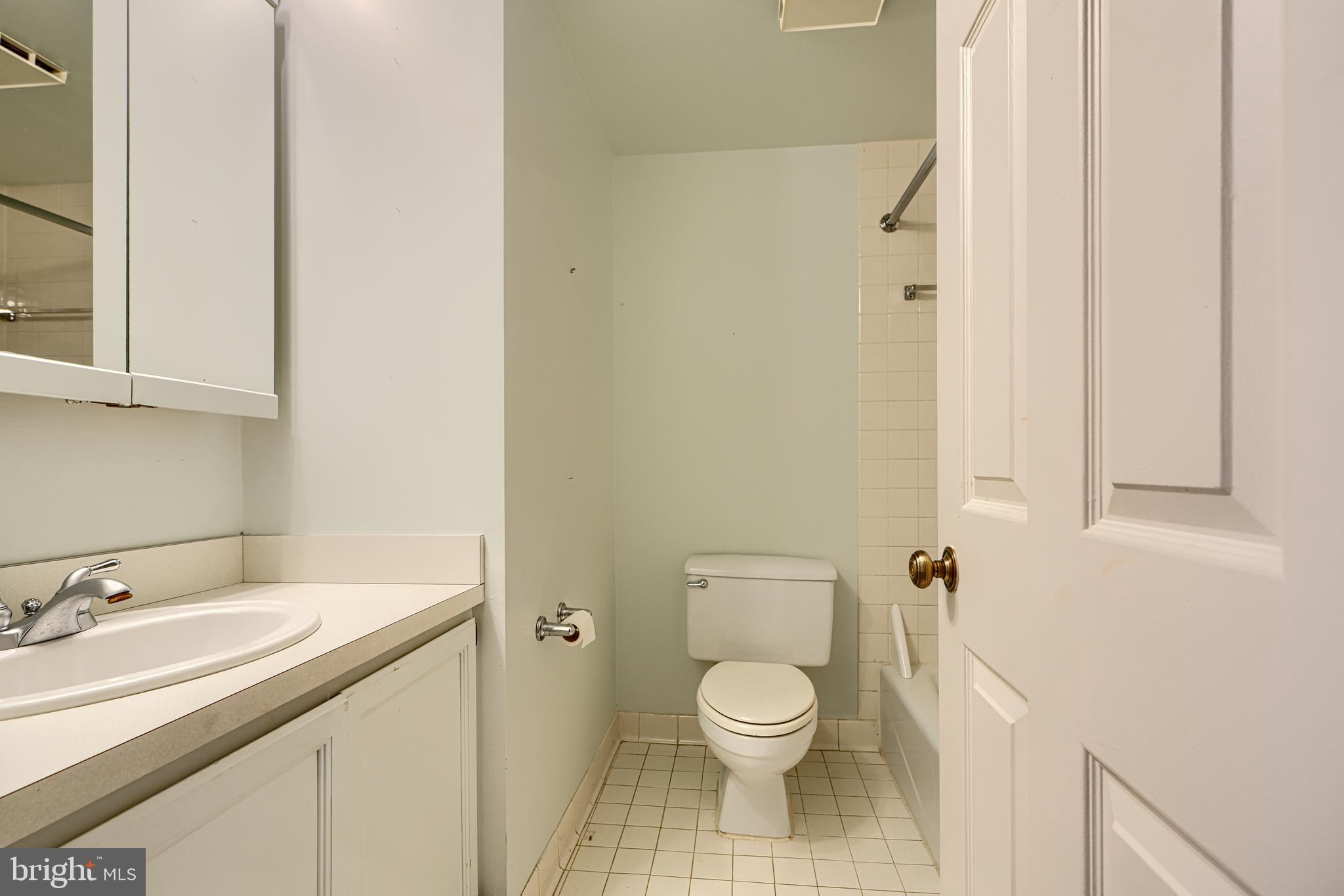 5712 Roland Avenue, Unit 1E Baltimore, MD 21210 - Photo 18 of 39 a bathroom with a sink toilet and vanity