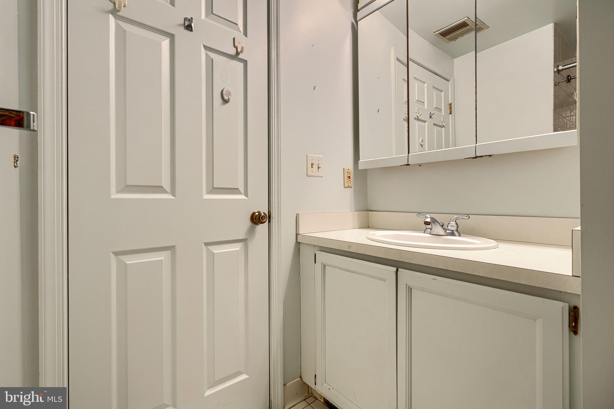 5712 Roland Avenue, Unit 1E Baltimore, MD 21210 - Photo 20 of 39 a bathroom with a sink and cabinets