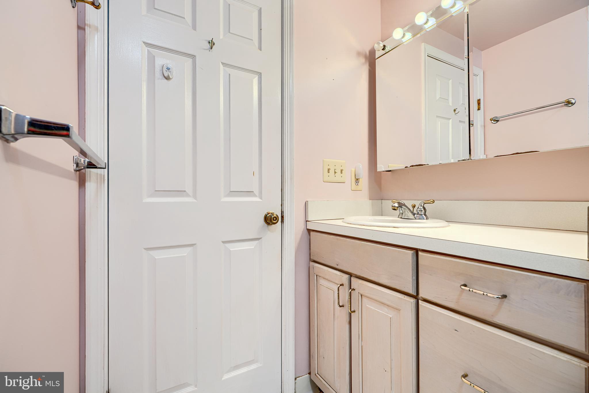 5712 Roland Avenue, Unit 1E Baltimore, MD 21210 - Photo 30 of 39 a bathroom with a sink and a mirror