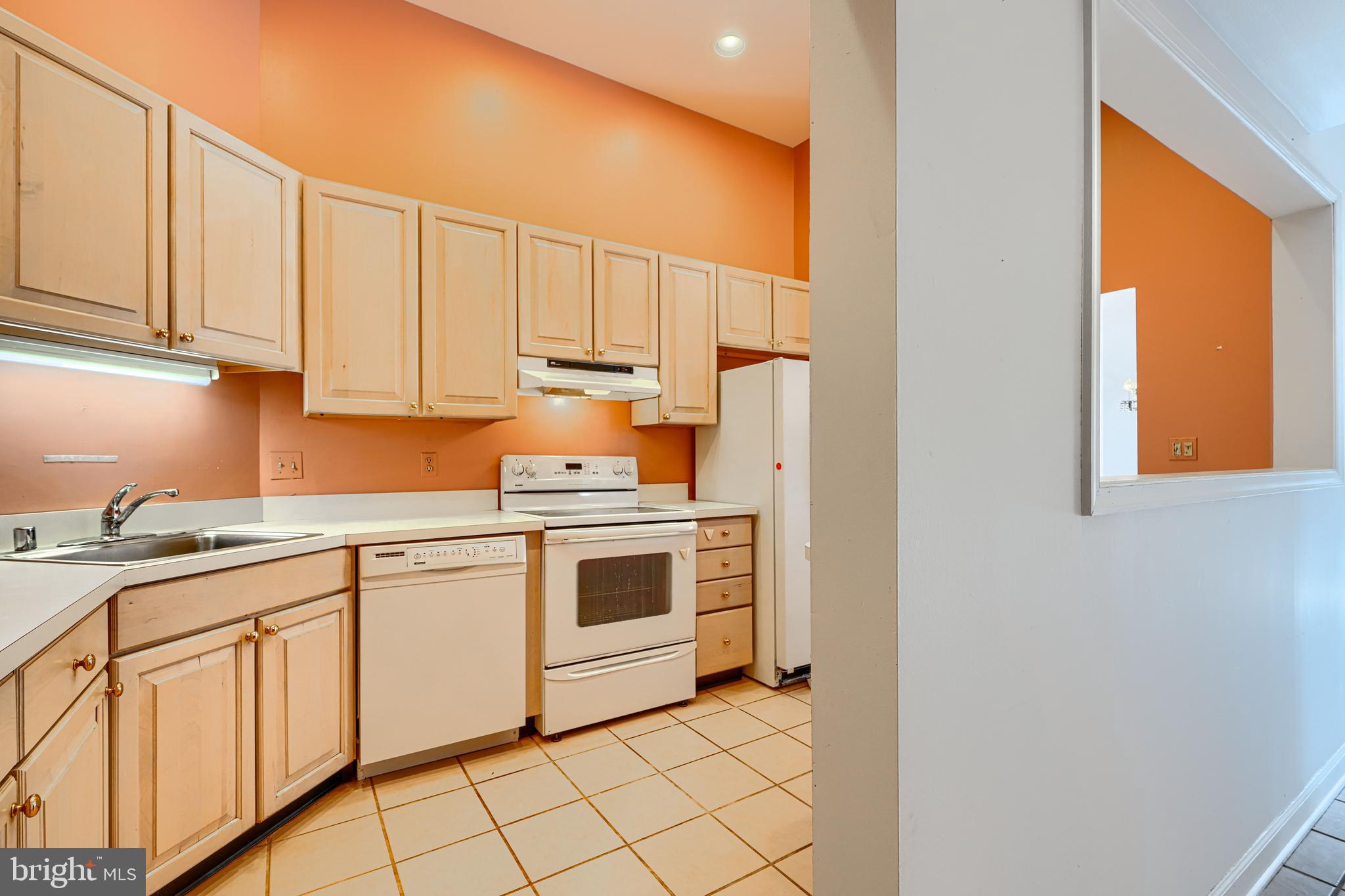 5712 Roland Avenue, Unit 1E Baltimore, MD 21210 - Photo 3 of 39 a kitchen with granite countertop white cabinets and white appliances