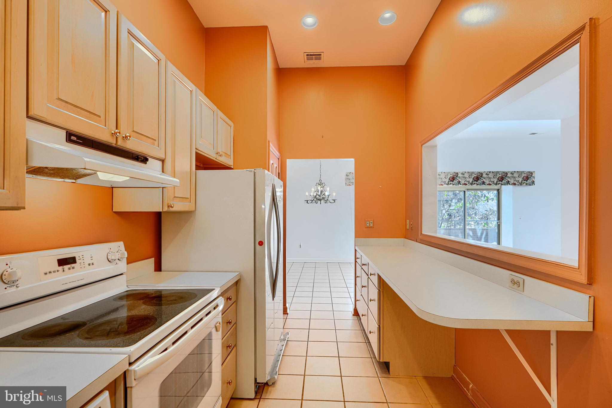 5712 Roland Avenue, Unit 1E Baltimore, MD 21210 - Photo 5 of 39 a kitchen with stainless steel appliances granite countertop a refrigerator and a stove