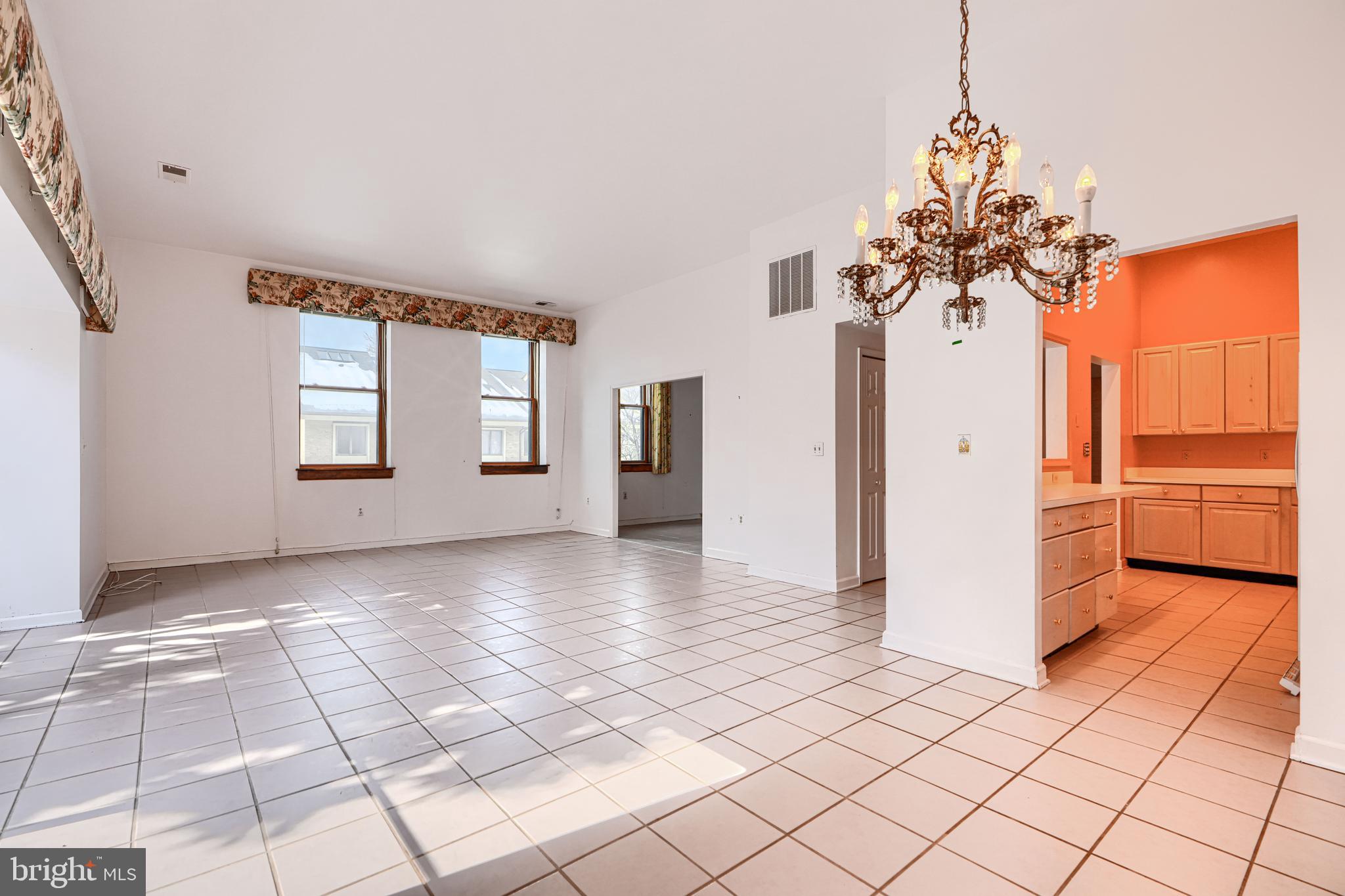 5712 Roland Avenue, Unit 1E Baltimore, MD 21210 - Photo 10 of 39 a view of a kitchen with a sink and a chandelier