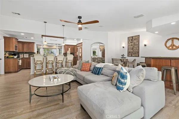 a living room with furniture and kitchen view