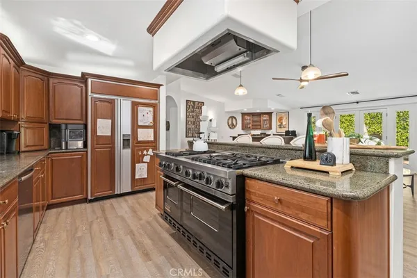 a kitchen with stainless steel appliances granite countertop a stove and a sink