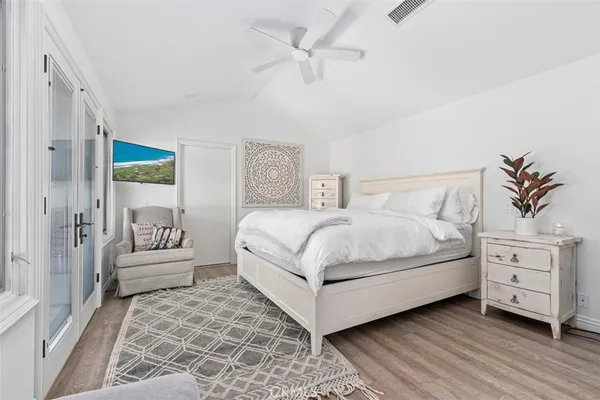a bedroom with a white bed and furniture
