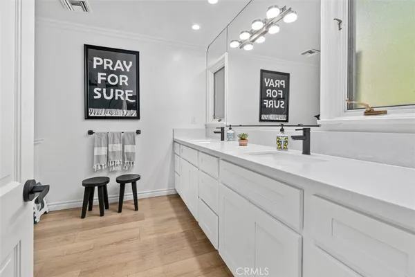 a bathroom with a granite countertop sink mirror and bathtub