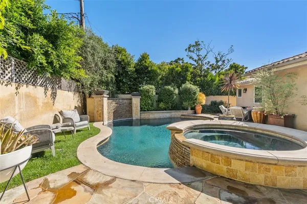 a view of a patio with table and chairs and potted plants