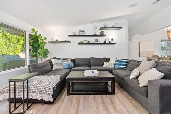 a living room with furniture and wooden floor