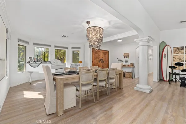 a view of a dining room with furniture window and wooden floor