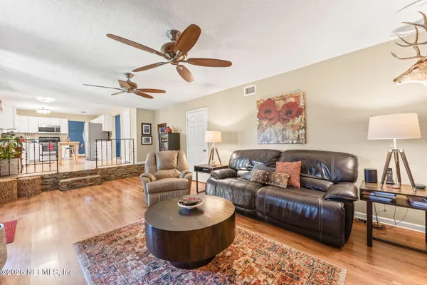 a living room with furniture a fireplace and a flat screen tv