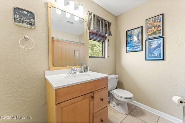 a spacious bedroom with a bed a bookshelf and a bookshelf with wooden floor