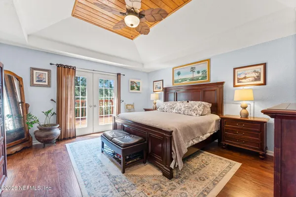a bedroom with furniture and a flat screen tv