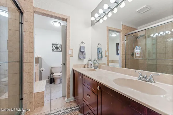 a white toilet sitting next to a bathroom sink and tub