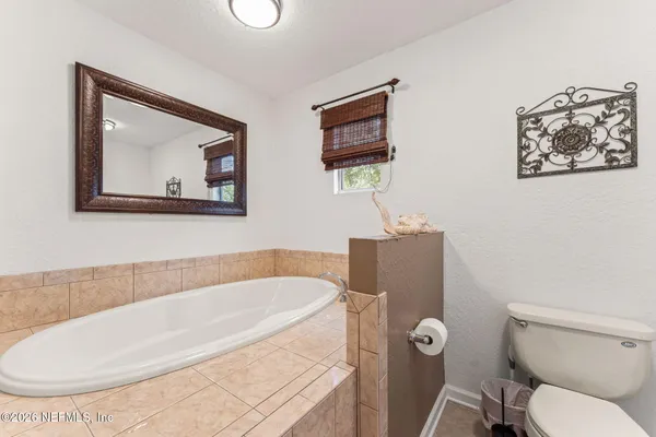 a bedroom with a bed and a bookshelf