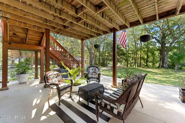 a view of a swimming pool with a table and chairs in patio