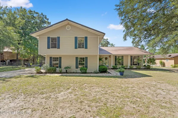 a view of a house with a yard and plants