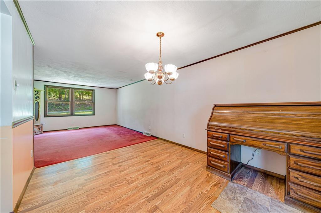 1124 Hemlock Road Indiana, PA 15701 - Photo 7 of 29 a bedroom with a bed and a chandelier