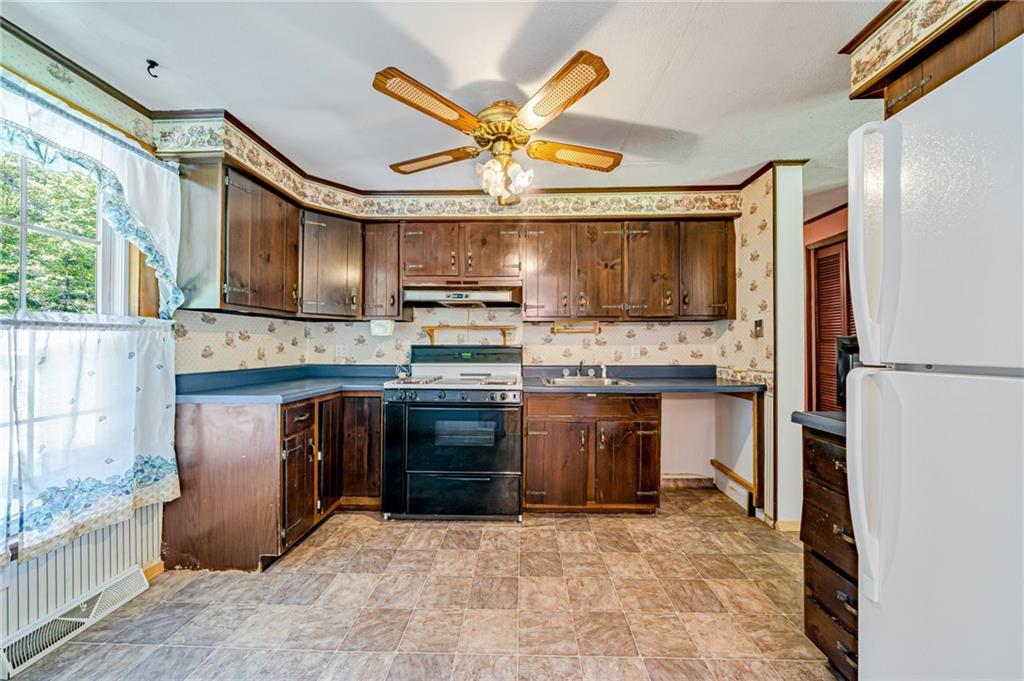 1124 Hemlock Road Indiana, PA 15701 - Photo 8 of 29 a kitchen with stainless steel appliances granite countertop a stove a sink and a refrigerator