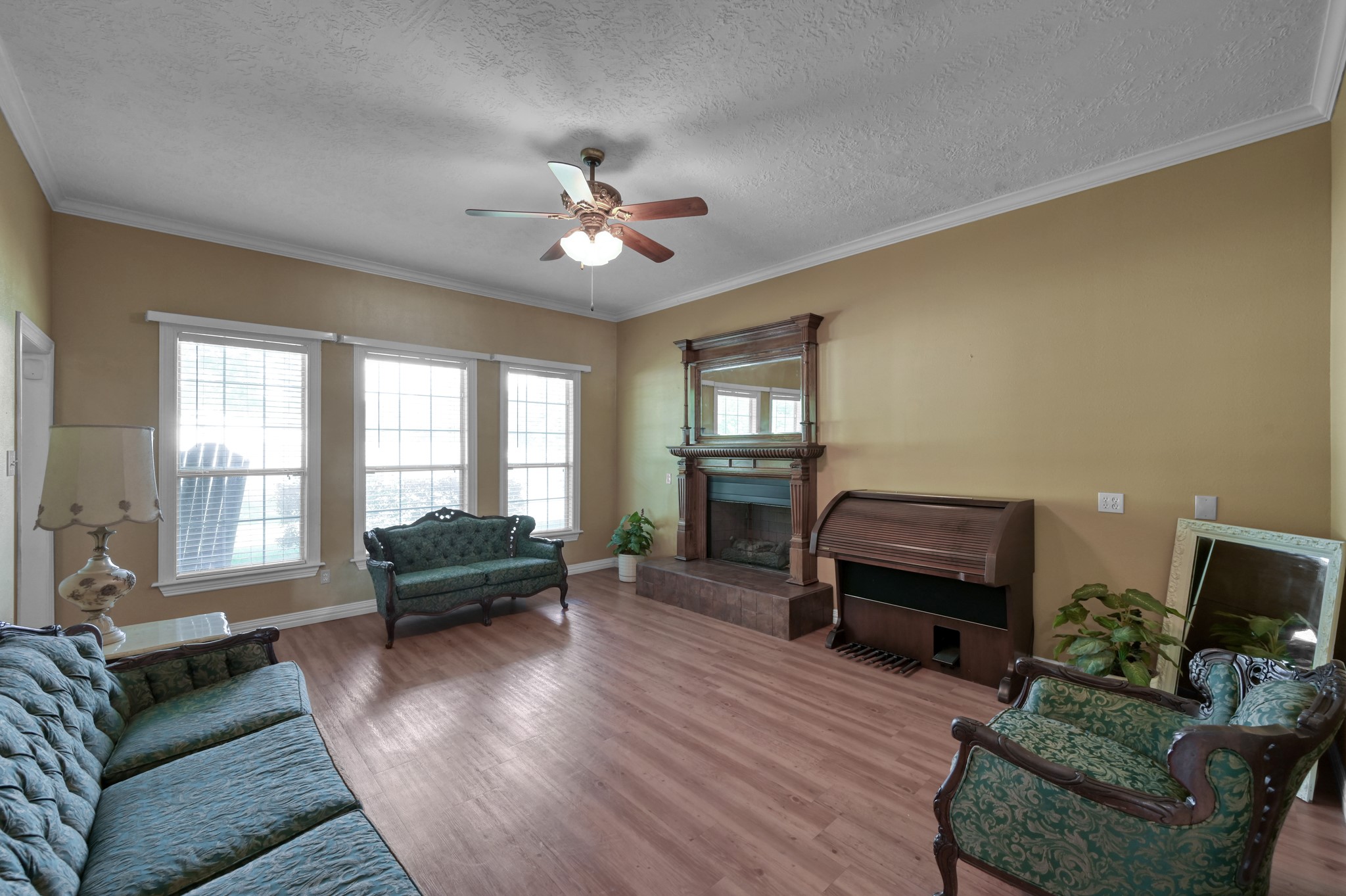 144 Wood Farm Road Huntsville, TX 77320 - Photo 7 of 35 a living room with furniture a ceiling fan a fireplace and a window