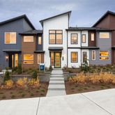 a front view of a residential apartment building with a yard
