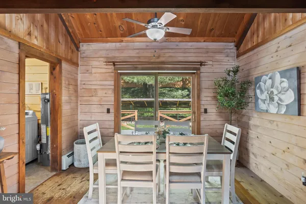 a living room with furniture floor to ceiling window and outdoor view