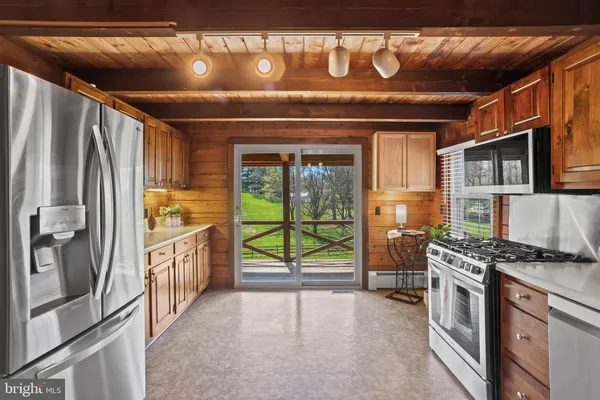 a kitchen with stainless steel appliances granite countertop a stove sink and cabinets