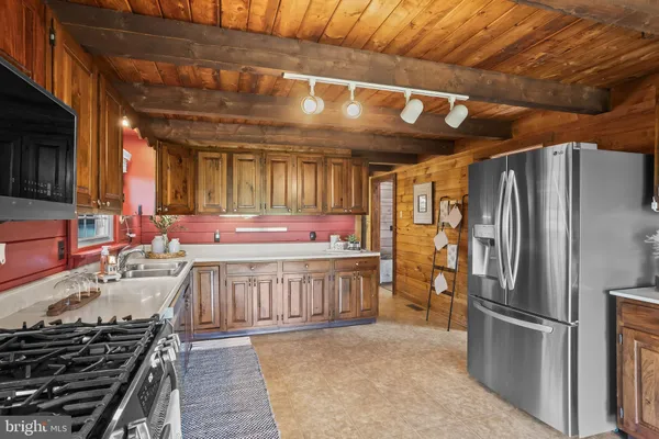 a kitchen with stainless steel appliances granite countertop a stove and a refrigerator