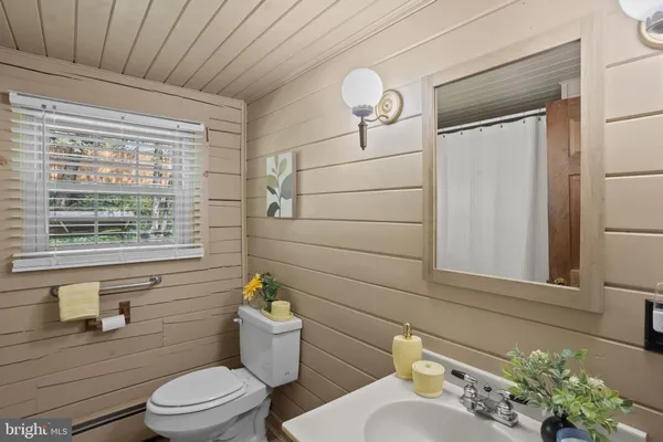 a bathroom with a toilet a sink and a window