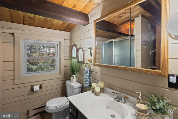 a bathroom with a sink a mirror and a shower