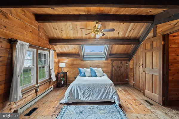 a living room with wooden floor furniture and a large window