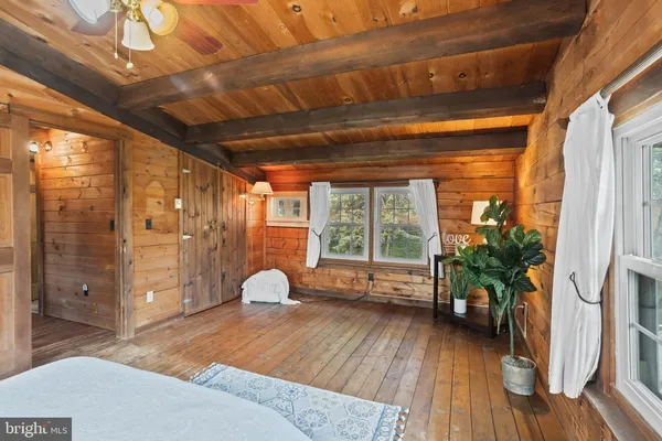 a view of a balcony with chairs and wooden floor