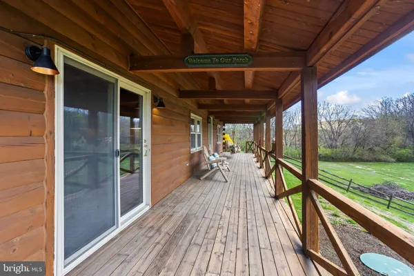 a view of balcony with wooden floor and seating space