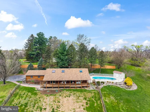 an aerial view of a house with pool yard and outdoor seating