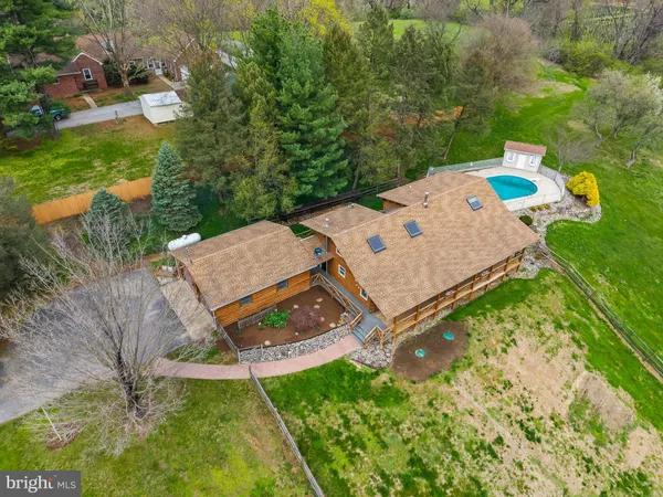 an aerial view of a house with garden space and street view