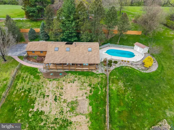 a aerial view of a house with pool