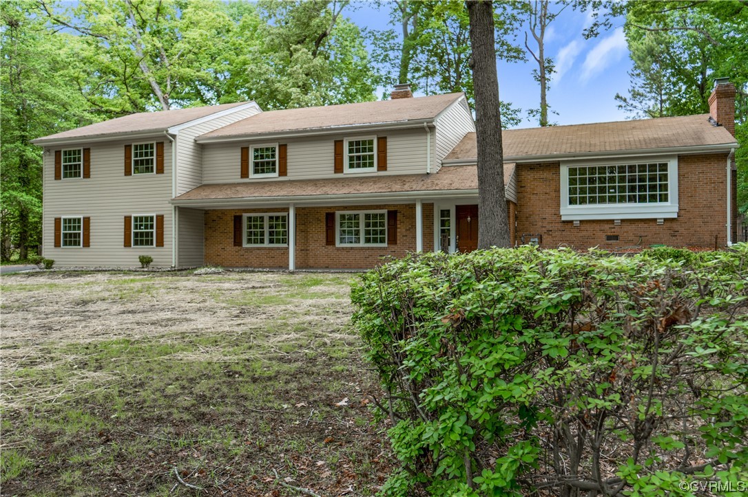 10240 Apache Road Richmond, VA 23235 - Photo 3 of 45 a front view of a house with a garden