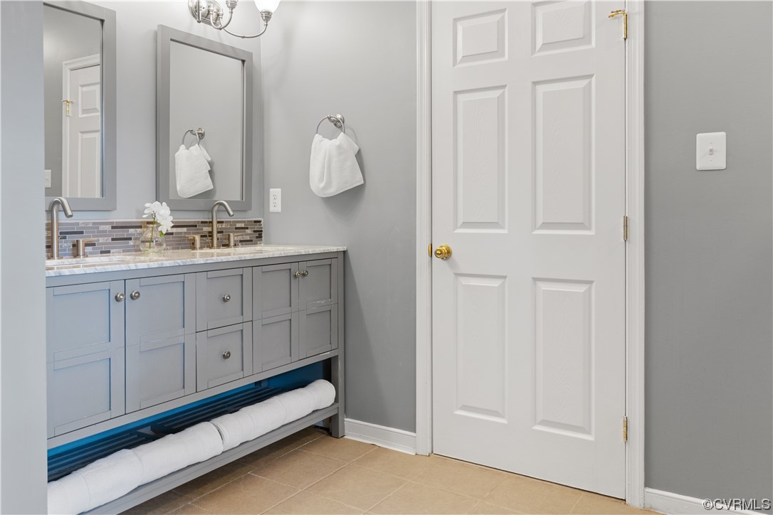 10240 Apache Road Richmond, VA 23235 - Photo 32 of 45 a bathroom with a double vanity sink and a mirror