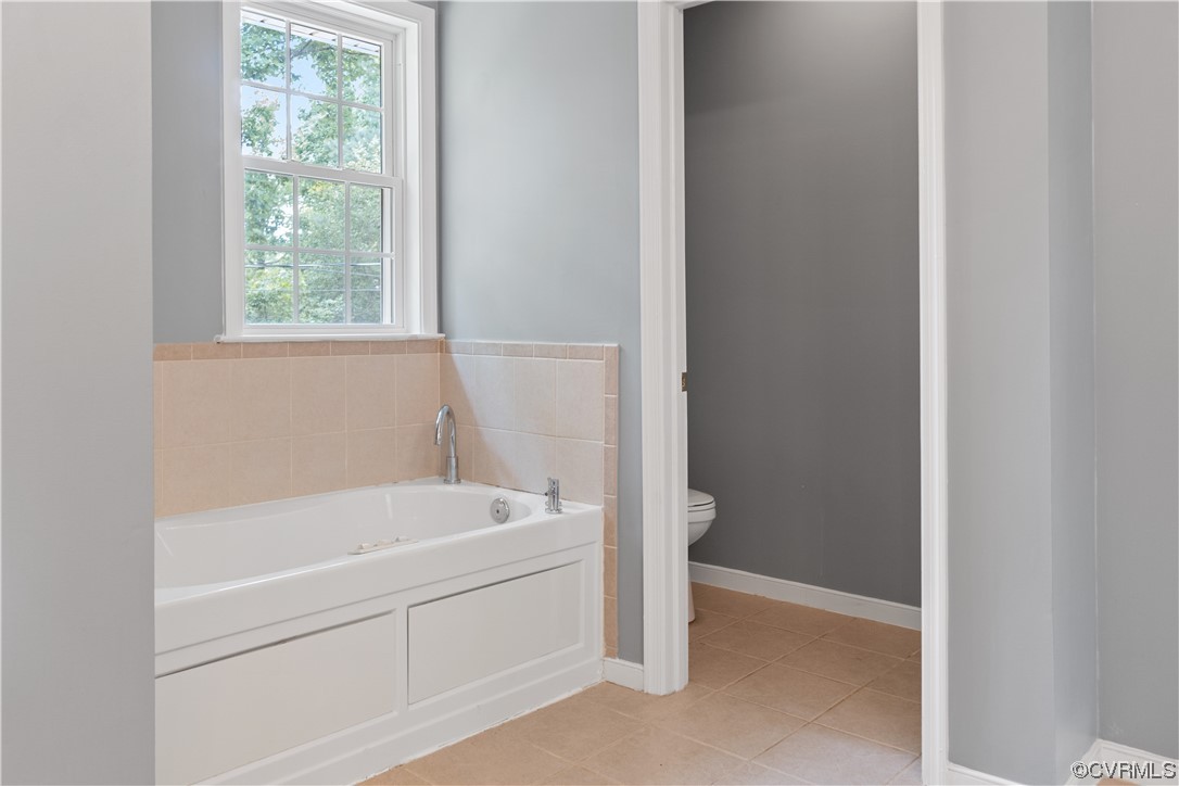 10240 Apache Road Richmond, VA 23235 - Photo 34 of 45 a white bath tub sitting next to a window