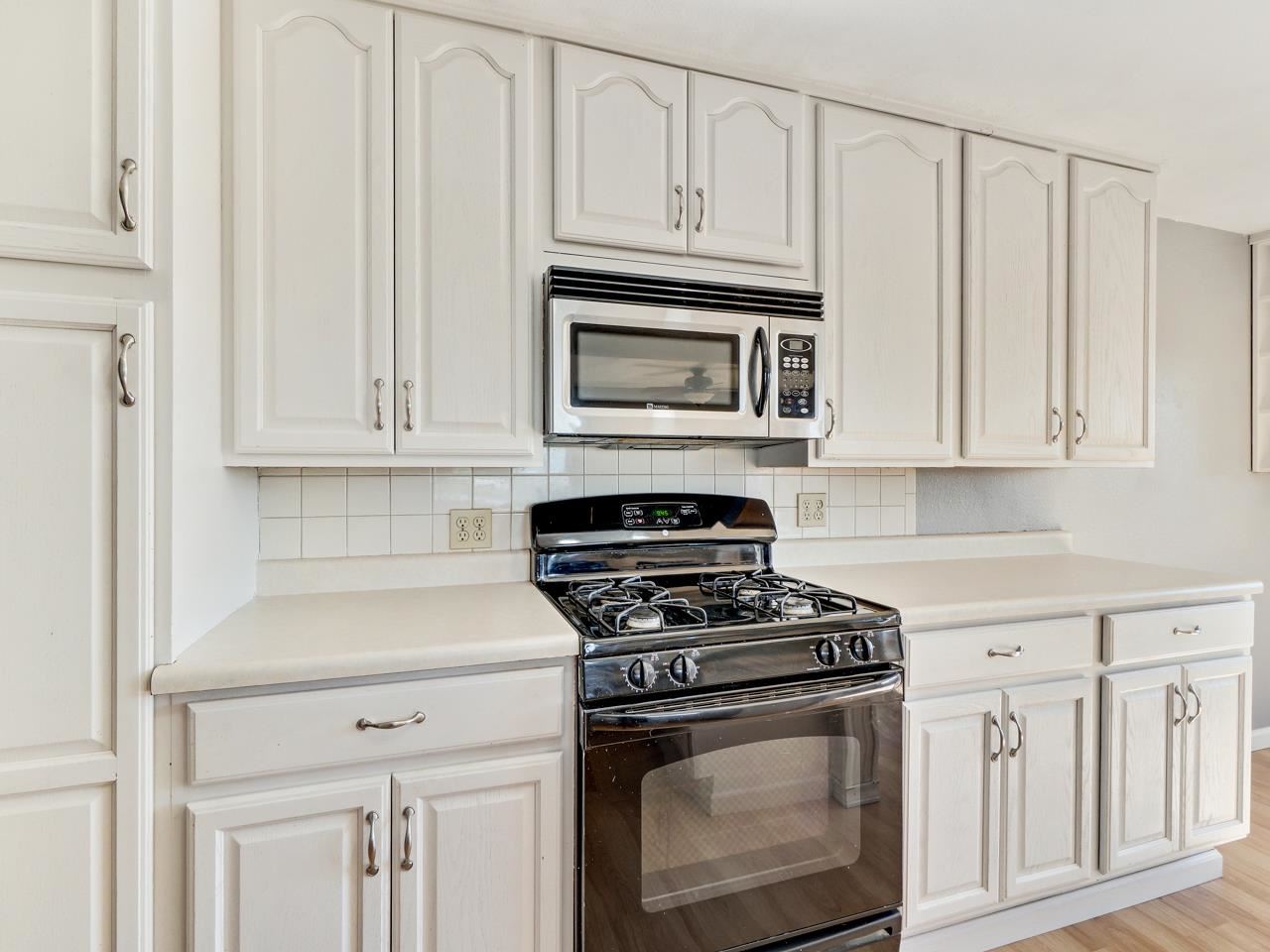 2278 H Road Grand Junction, CO 81505 - Photo 12 of 38 a kitchen with white cabinets and stainless steel appliances